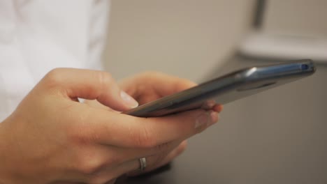 Cute-girl-uses-smartphone-at-work