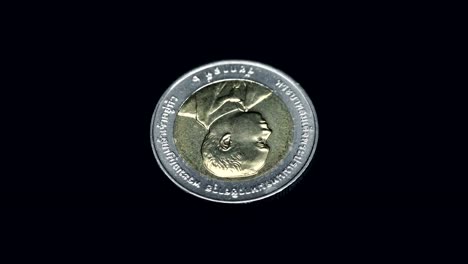 Commemorative-coin-of-Thailand-(baht)-rotates-on-a-black-background.-Macro.-Closeup