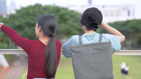 back-of-people-women-talking-at-outdoor-space-public-park.-Concept-fashion-girls-lifestyle.