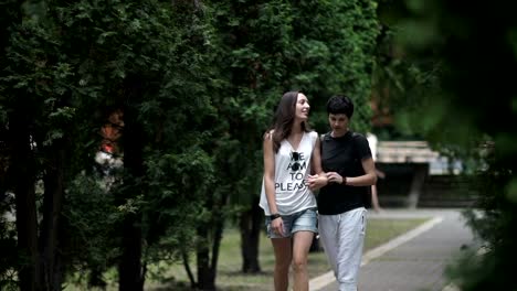 Two-lesbians-holding-hands-and-walking-in-the-park