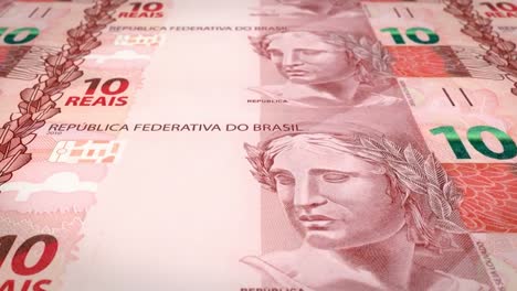 Banknotes-of-ten-brazilian-reals-rolling-on-screen,-cash-money,-loop