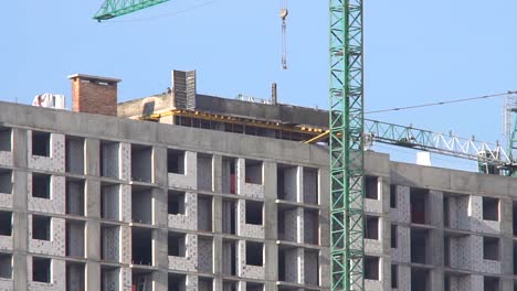 Construction-of-a-high-rise-apartment-house.-The-construction-crane-works-at-the-construction-site.-Construction-of-new-residential-property