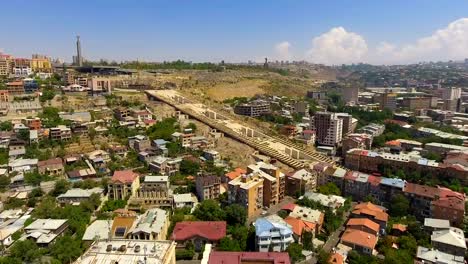 Tourism-in-Yerevan,-exciting-aerial-view-of-Cascade-stairway-and-buildings