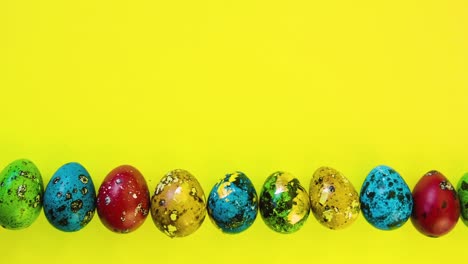 Easter-eggs-lined-in-a-row-on-a-yellow-background.