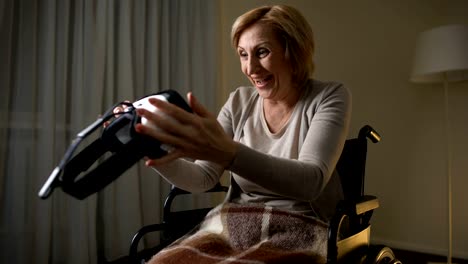 Woman-in-wheelchair-holding-vr-glasses-and-showing-thumbs-up-happy-and-surprised