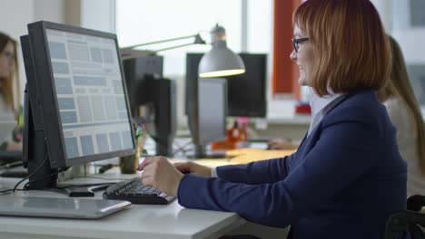 Disabled-Businesswoman-Working-at-Office-Desk