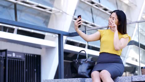 Young-business-lady-making-selfies-on-mobile-phone