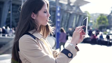 Young-attractive-Caucasian-woman-using-tablet-computer-at-train-station