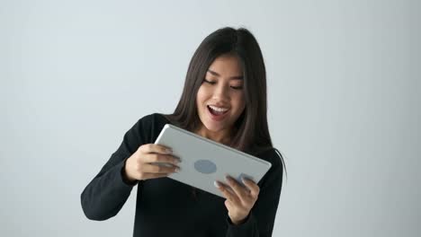 Woman-playing-game-on-digital-tablet