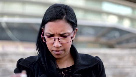 Thoughtful-hindu-businesswoman-in-eyeglasses-with-tablet.