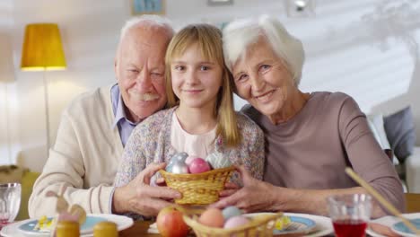 Portrait-of-Grandparents-and-Granddaughter-with-Basket-of-Eggs