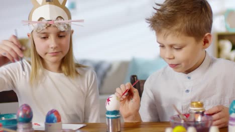 Cute-Siblings-Painting-Eggs-for-Easter