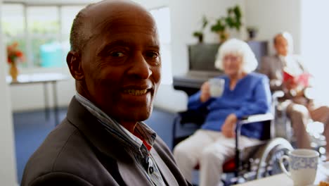 Side-view-of-African-American-senior-man-smiling-in-nursing-home-4k