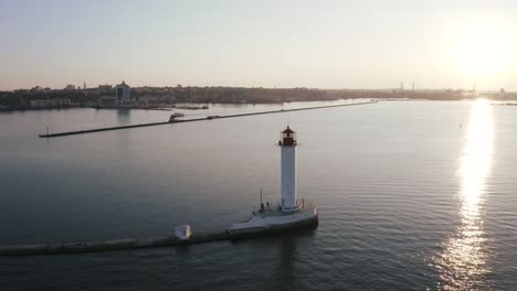 Toma-aérea-de-faro-blanco-cerca-del-puerto-marítimo,-360-ver