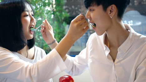 Young-Asian-Lesbian-Couple-Feeding-Sweet-Rainbow-Cake,-LGBT-Love-Moment-Slow-motion