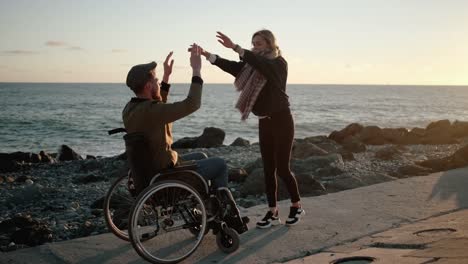 Disabled-man-with-cheerful-woman-friend-outdoors