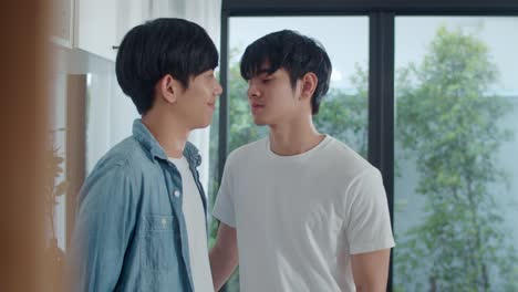 Asian-Gay-couple-standing-and-hugging-room-at-home.-Young-handsome-LGBTQ+-men-kissing-happy-relax-rest-together-spend-romantic-time-in-modern-kitchen-at-house-in-the-morning-concept.