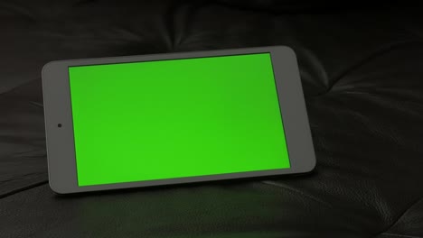 Exposed-on-couch-modern-tablet-with-green-screen-display-4K