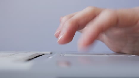 Man-using-trackpad-on-a-laptop-notebook-mobile-computer