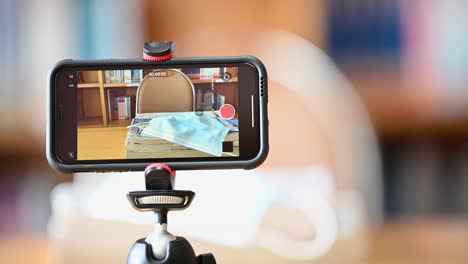 A-mobile-phone-mounted-on-a-tripod-is-used-to-teach-students-online-at-the-library.