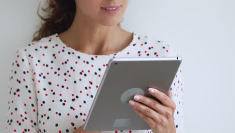 Closeup-view-female-using-tablet-having-fun-on-internet