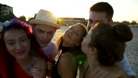 Group-of-friends-making-funny-faces-on-video-call-at-the-beach