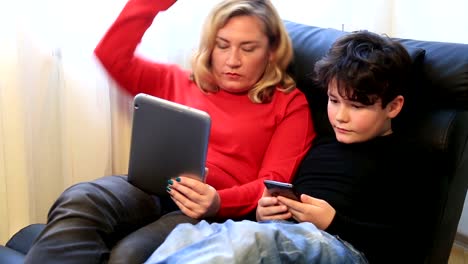 Mother-and-son-using-digital-equipment