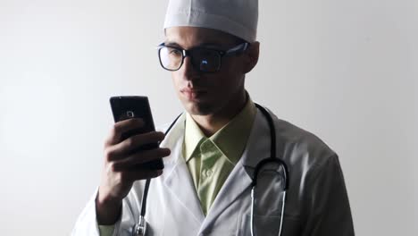 The-doctor-uses-a-smartphone.-Medical-worker-surfing-the-Internet-using-a-mobile-phone.