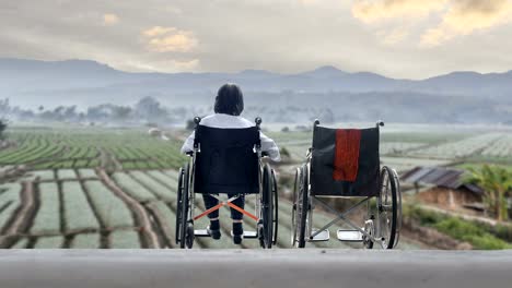 Elderly-woman-with-empty-wheelchair-standing-together