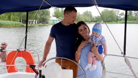 mum,dad-and-son-in-open-air,-happy-parents-with-child-on-rest-in-background-nature-and-water,-mother,-father-and-little-baby