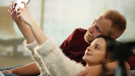 Cheerful-couple-on-sofa