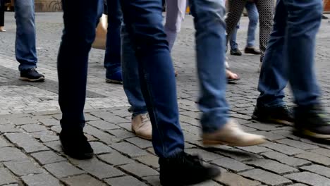 Lot-of-feet-a-crowd-of-people-strolling-along-the-cobbles-of-the-city