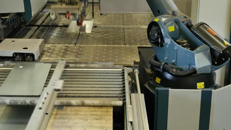 Robot-arm-in-a-metal-factory-picks-up-metal-plates