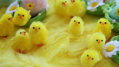 Baby-yellow-Easter-toys-chicks-and-eggs-on-a-background-of-feathers.-Festive-video-greeting-card