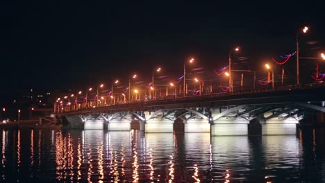 Chernavsky-Bridge-with-illumination-at-night-and-reflection-of-lights-in-water,-Voronezh