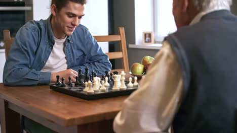 Grandfather-Playing-Chess-with-Adult-Grandson