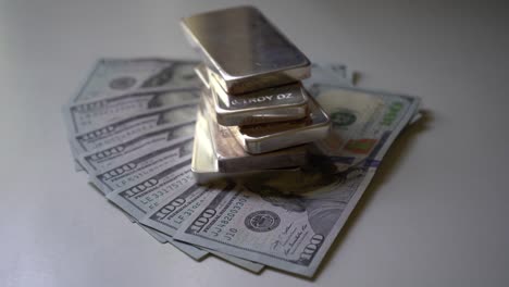 Silver-Bars-on-Top-of-Hundred-Dollar-Bills-Zooming-In