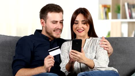 Couple-shopping-online-with-credit-card-at-home