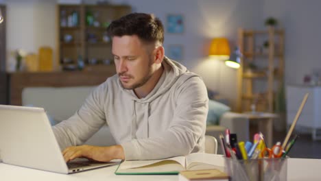 Man-Working-on-Laptop-at-Home