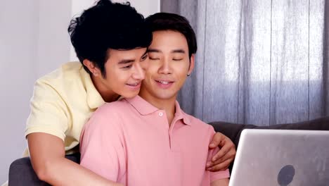 Gay-couple-using-laptop-together-with-happy-emotion.-People-with-gay,-homosexual,-lifestyle-and-technology-concept.