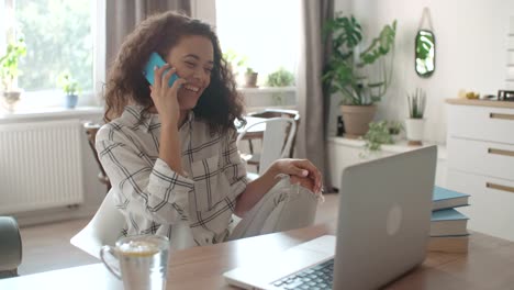 Young-woman-using-mobile-phone-at-home.