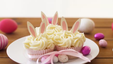 cupcakes-with-easter-eggs-and-candies-on-table