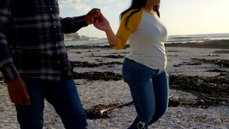 Couple-walking-with-hand-in-hand-at-beach-on-sunny-day-4k