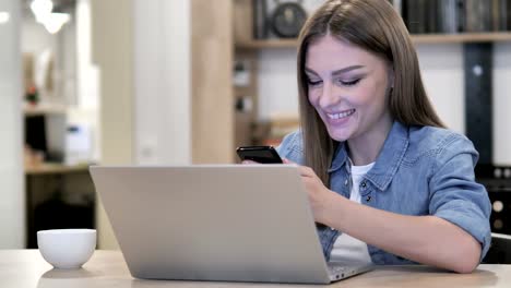 Happy-Young-Girl-Text-Messaging-on-Phone