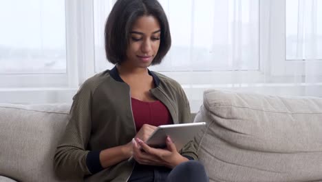 Teenage-girl-using-digital-tablet-at-home