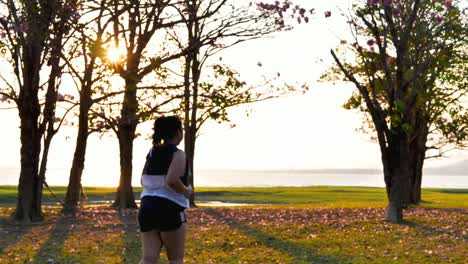 An-Asian-woman-jogging-in-natural-sunlight-in-the-evening.
She-is-trying-to-lose-weight-with-exercise.--concept-health-with-exercise.-Slow-Motion