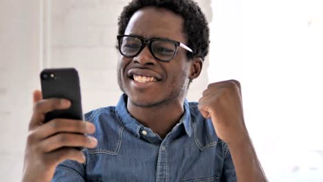 Excited-Man-Enjoying-Success-while-Using-Smartphone