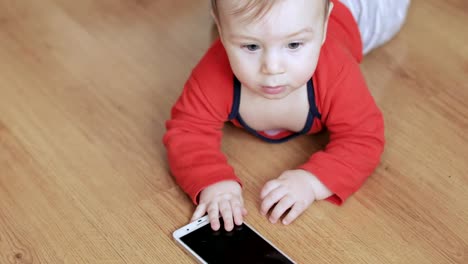 Baby-Boy-spielt-mit-einem-Smartphone