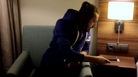 Handsome,-young-man-with-tablet-computer-sitting-on-chair-at-home