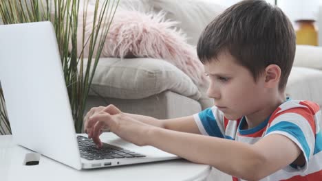 Boy-e-learning-on-laptop-at-home